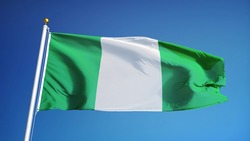 Nigeria flag waving against clean blue sky, close up, isolated with clipping path mask alpha channel transparency
