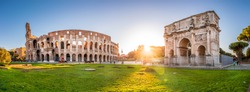Panorama of Colosseum and Constantine arch at sunrise in Rome. Rome architecture and landmark. Rome Colosseum is one of the main attractions of Rome and Italy.
