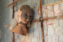 Head of a doll with a gloomy appearance. Halloween decoration