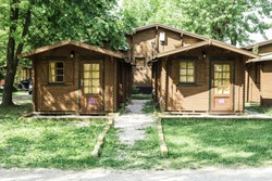 Wooden bungalows on campsite camping. Green trees