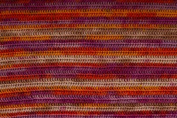 Texture of warm colored gradient cotton cloth made with treble (double) crochets 