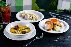 Enjoy your meal. Set of three delicious dishes served on a restaurant table, full set of three dishes for lunch in a cafe