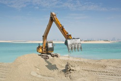 Large scale marine land reclamation and artificial island building works in the UAE, Middle East showing dredged coral sand and erosion of shoreline