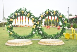 Turmeric Ceremony Beautiful Stage. Flowers and Grass Decoration. Hindu Wedding Rituals and Ceremony. Special Stage Decoration