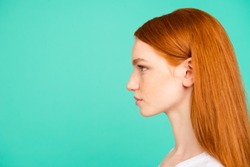 Profile side view portrait of nice positive calm content attractive cute bright vivid shiny red straight-haired girl in casual white t-shirt, isolated on turquoise green teal pastel background