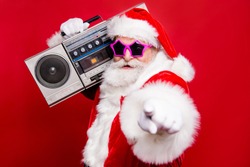 Disco trendy noel christmastime eve winter wish December stylish funky aged mature star Santa tradition costume white beard vintage record indicate show point fingers isolated red background