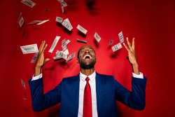 Attractive multiethnic man in style chic classy jacket blue formalwear  trendy tux tuxedo stand with closed eyes under money fly rain isolated on red vivid background raised hands up