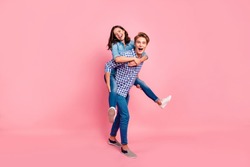 Close up full length body size photo of piggy back hugging she her he him his lady guy boy going to competitions best team wearing casual jeans denim plaid shirts isolated on rose background