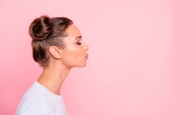 Profile side view portrait of her she nice cute attractive lovely sweet cheerful girl lady kissing you isolated over pastel pink background