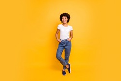 Full length body size photo beautiful amazing she her dark skin lady lovely look self-confident optimistic nice cool wear casual white t-shirt isolated yellow bright vibrant vivid background