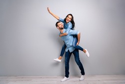 Full length body size photo funky cheer she her he him his lady guy piggyback ride walk meet adventures hand arm up run runner wear casual jeans denim shirts outfit clothes isolated grey background