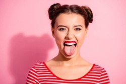 Close up photo beautiful amazing she her lady impolite careless pretty hairdo two buns bright pomade allure big lips tongue out mouth wear casual striped red white t-shirt isolated pink background