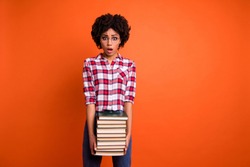 Portrait of nice cute attractive smart clever intelligent wavy-haired lady wearing checked shirt carrying holding many different book isolated over bright vivid shine orange background