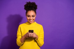 Portrait of her she nice attractive lovely winsome focused cheerful cheery wavy-haired girl holding in hands device chatting on web isolated over bright vivid shine violet background