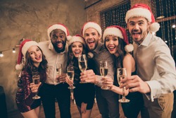 Portrait of leaning guy and ladies enjoy christmas night celebrate x-mas noel give toast screaming wearing dress shirt cap pants in house with newyear illumination decoration indoors