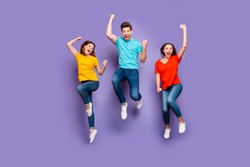 Full length size body photo of three crazy funky carefree buddies teamwork company raising fists up isolated violet background