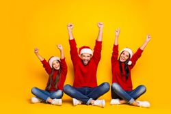 Full length body size photo of cheerful excited cute nice family excited crazy with winter holiday started wearing jeans denim  red sweater overjoyed sitting on floor isolated over color background