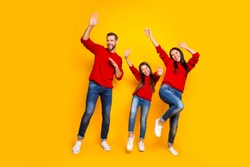 Full length body size photo of crazy cheerful nice hilarious family dancing on weekend in motion screaming about sales discounted wearing jeans denim isolated over vivid color background yellow