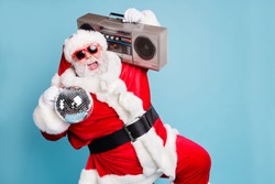 Portrait of his he nice cool fat cheerful cheery glad excited ecstatic overjoyed crazy carefree bearded Santa carrying tape player dancing having fun isolated on blue turquoise pastel color background
