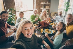 Photo of big family sit feast dishes table around roasted turkey multi-generation relatives making group selfies raising wine glasses juice in living room indoors