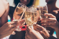Cropped photo of many people hanging out clink glasses with champagne
