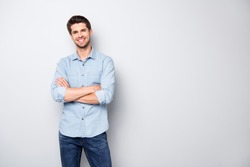 Portrait of positive cheerful cool college university man cross hand feel like true leader person wear denim jeans style outfit isolated over grey color background