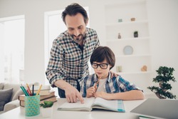 Doing home task with best daddy concept. Photo of two people positive patient intelligent daddy helping his offspring with homework preparation and tests