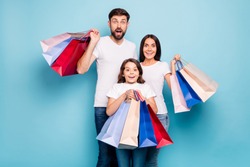 50% off! Real bargain concept. Portrait of excited three people mom dad schoolkid shop center hold bags scream wow omg wear white t-shirt denim jeans isolated over blue color background
