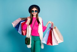 Portrait of her she nice attractive cheerful cheery girl carrying new clothing things spending holiday isolated on bright vivid shine vibrant green blue turquoise color background