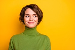 Closeup photo of funny short hairdo lady charming smiling good mood looking side empty space sly eyes wear casual green warm turtleneck isolated yellow color background