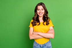 Portrait of her she nice attractive lovely charming pretty cute cheerful cheery content wavy-haired girl folded arms isolated on bright vivid shine vibrant green color background