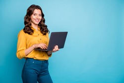 Portrait of her she nice attractive confident cheerful cheery wavy-haired girl holding in hands laptop creating web design isolated on bright vivid shine vibrant green blue turquoise color background