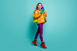 Full size photo of cheerful dreamy woman go walk winter lectures hold bag wear yellow pink purple red green jumper outfit isolated over teal color background