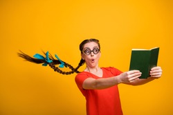 No way! Photo of funny student lady open mouth clever person hairdo flight read exciting book not believe eyes intrigue wear casual red t-shirt isolated vibrant yellow color background