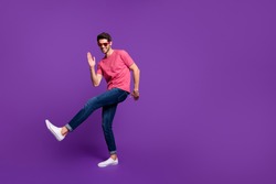 Full size photo of cheerful candid funny guy dance discotheque enjoy music night club wear good look outfit gumshoes isolated over purple shine color background