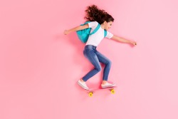 Top view above high angle flat lay flatlay lie concept full length body size view of nice cheerful cheery girl jumping standing on board riding having fun isolated on pink pastel color background
