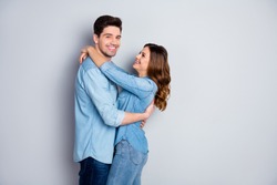 Portrait of positive passionate married couple woman man hug embrace enjoy together wear casual style clothes isolated over gray color background
