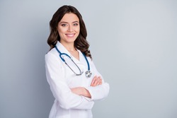 Profile photo of attractive family doc lady patients consultation friendly smiling reliable virology clinic arms crossed wear white lab coat stethoscope isolated grey color background