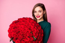 Photo of charming lady red bright lipstick enjoy large hundred roses bouquet boyfriend 8 march present wear green dress isolated pastel pink color background