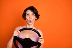 Portrait of astonished girl hold steering wheel ride drive car taxi impressed fast speed road wear good look singlet isolated over shine color background