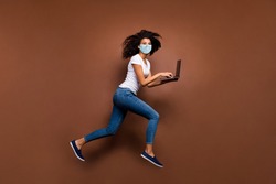 Full length body size profile side view of her she attractive healthy wavy-haired girl wearing gauze safety mask jumping using laptop running stop cov ncov-2 isolated dark brown color background