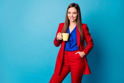 Photo of attractive business lady holding hot morning coffee mug enjoy amazing fresh beverage wear luxury trend red suit with blouse shirt isolated blue color background