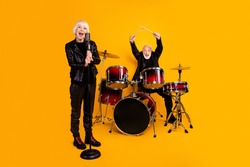 Portrait of his he her she nice attractive cheerful excited grey-haired couple performing singing playing live show scene fame isolated over bright vivid shine vibrant yellow color background