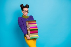 Portrait of her she nice attractive pretty smart clever tired girl geek carrying big large heavy pile books isolated on bright vivid shine vibrant blue green teal turquoise color background