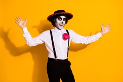 Photo of spooky funky guy crazy attempt jump scare appear from nowhere surprise everyone carnival wear white shirt rose death costume sombrero suspenders isolated yellow color background