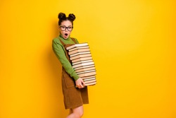 Portrait of her she nice attractive overwhelmed intelligent girl carrying big large pile book materials science project isolated bright vivid shine vibrant yellow color background