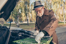 Photo of pensioner grandpa choosing instrument prepare car repair wear brown jacket cap specs outdoors