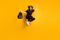 Full length body size portrait of man jumping shouting loudly celebrating great discount on black friday sale isolated on bright yellow color background