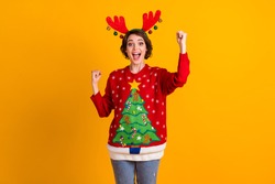 Photo of excited girl in christmas tree sweater pullover deer headband balls raise fists x-mas time noel lottery sale win isolated over bright shine color background