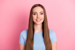 Photo portrait of girl with long brown hair smiling wearing blue casual t-shirt isolated on pastel pink color backgroung